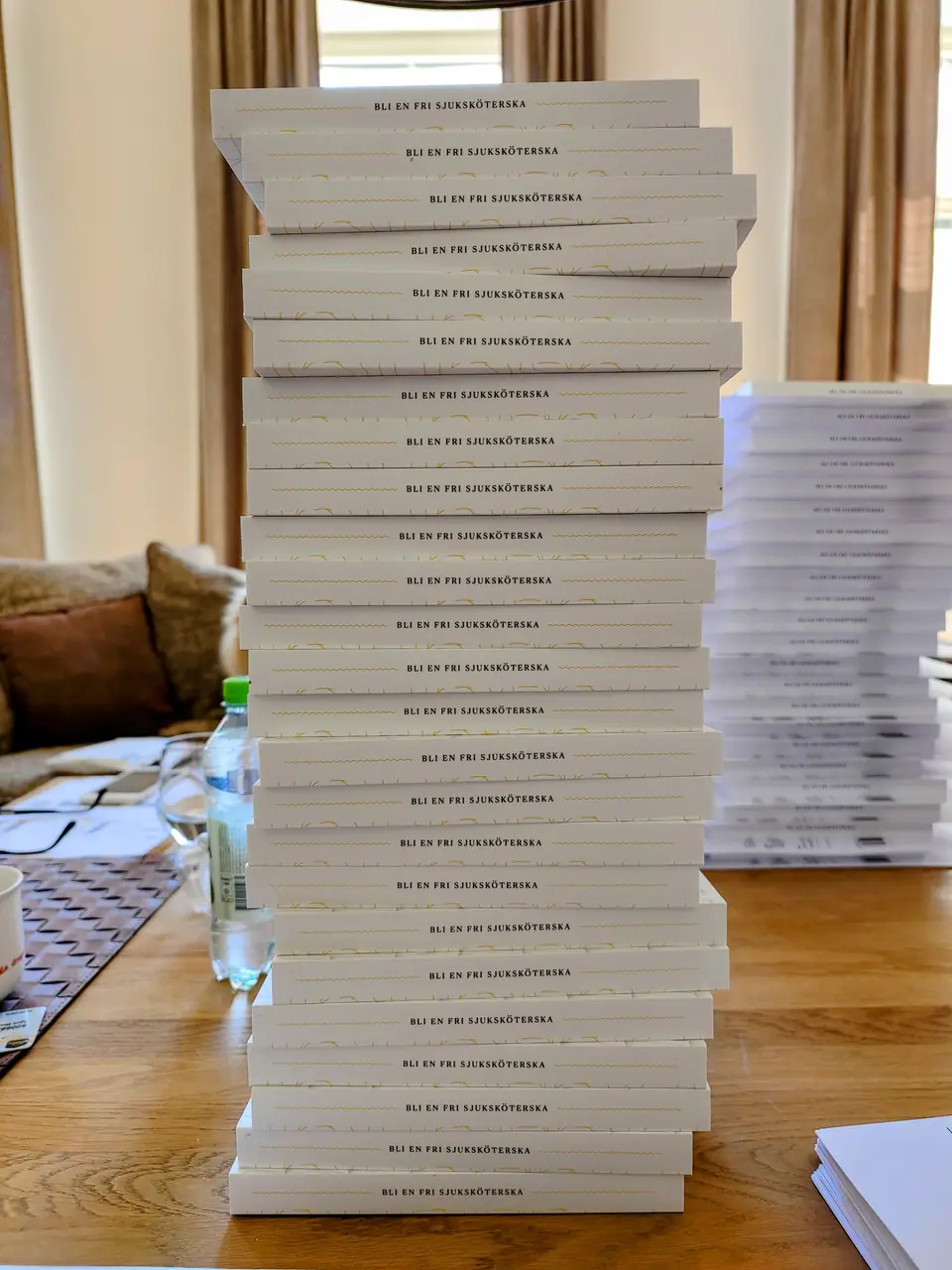 A tall stack of the book on a table