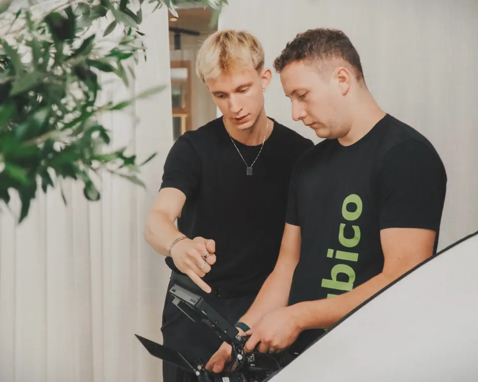 Two crew members, one in a Yubico T-shirt, checking a shot on a camera