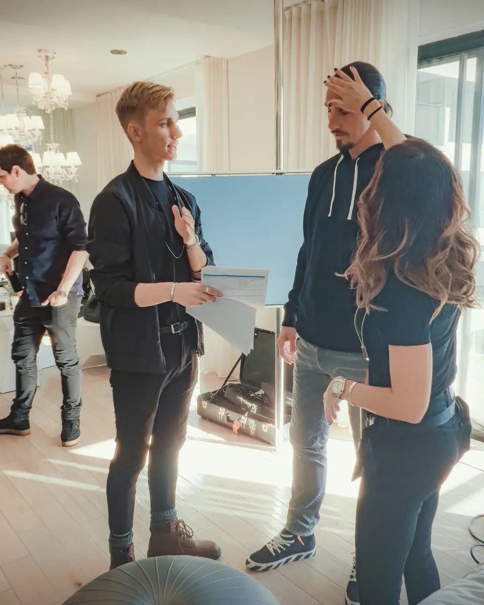 Talking through a scene with Zlatan Ibrahimović and a crew member in a bright apartment
