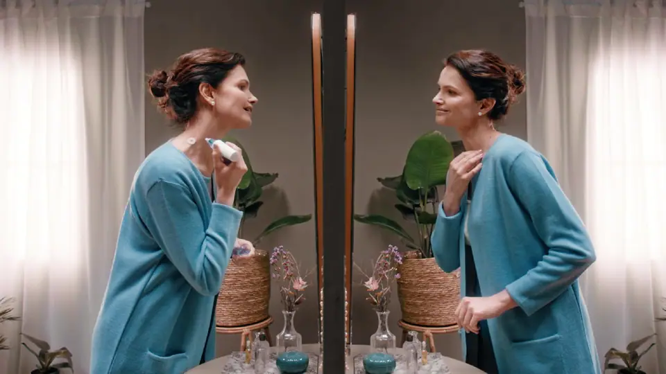 A woman and her mirror image facing each other, each making a different choice