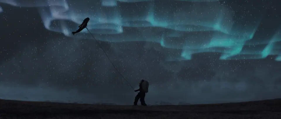 A lone figure under the northern lights in Iceland