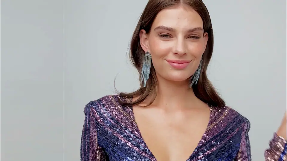 Banner film: a model in a sequin dress tries on statement fringe earrings