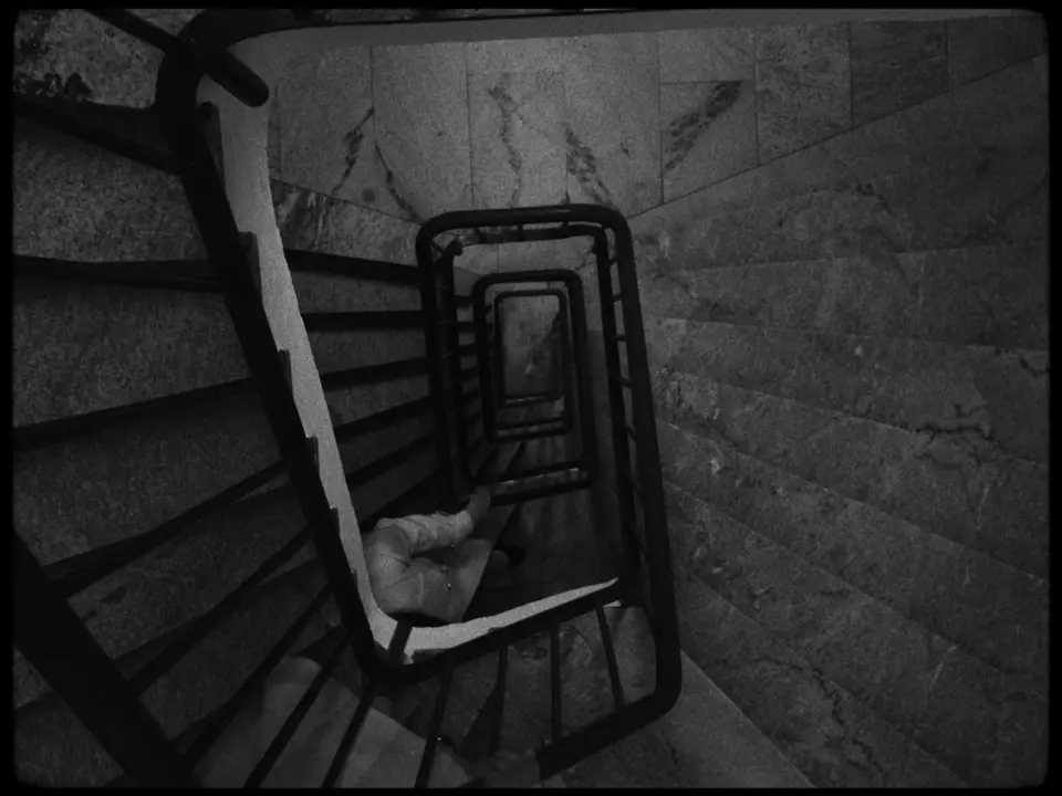 Looking down a spiral staircase in black and white